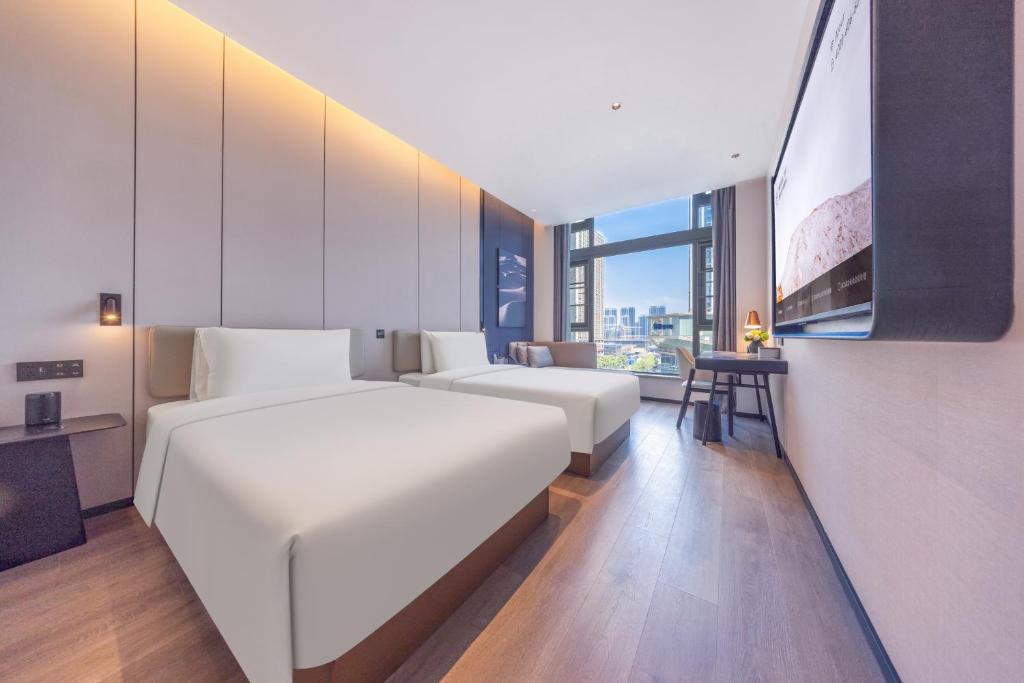 Postel nebo postele na pokoji v ubytování Atour Hotel Changsha Financial Center Chazishan Road