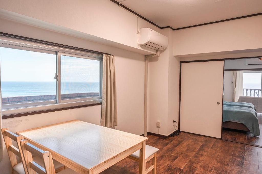 Postel nebo postele na pokoji v ubytování 白浜大洋マンション