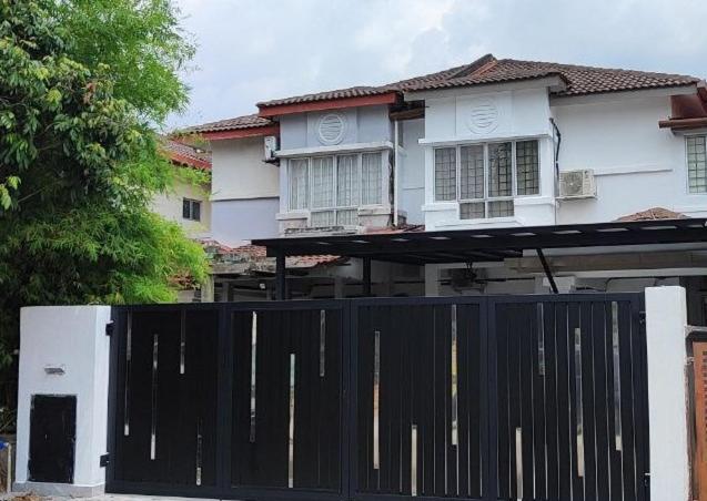 a black gate in front of a white house at Homestay Anggerik 56 Saujana Utama in Sungai Buluh