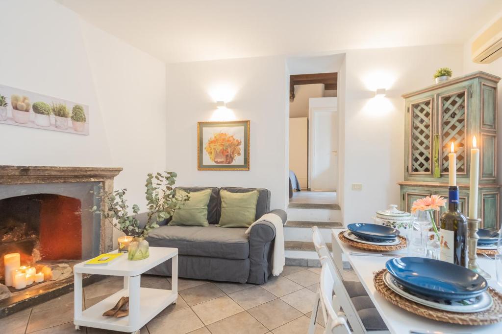 a living room with a couch and a fireplace at Up On the Roof by Rent All Como in Como