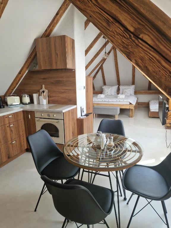a kitchen with a table and chairs in a room at Apartmán v Podkroví in Kremnica