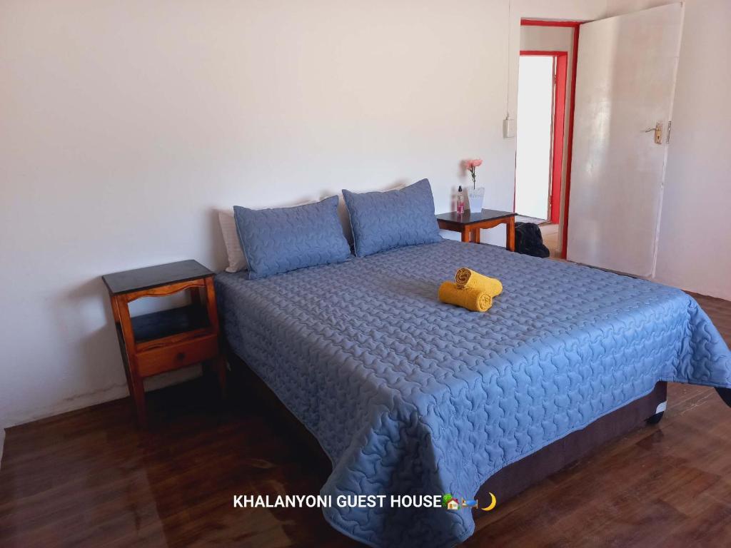 Ένα ή περισσότερα κρεβάτια σε δωμάτιο στο Khalanyoni Guest House