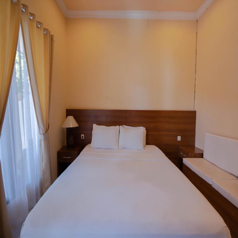 Postel nebo postele na pokoji v ubytování Urbanview My Home One Gili Trawangan