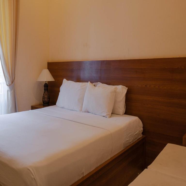 Postel nebo postele na pokoji v ubytování Urbanview My Home One Gili Trawangan