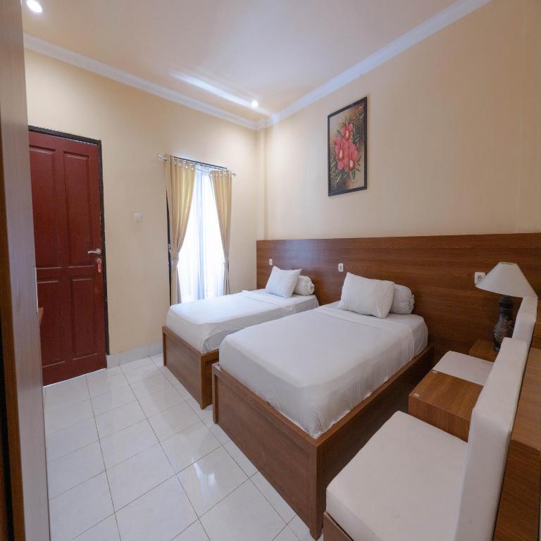 Postel nebo postele na pokoji v ubytování Urbanview My Home One Gili Trawangan