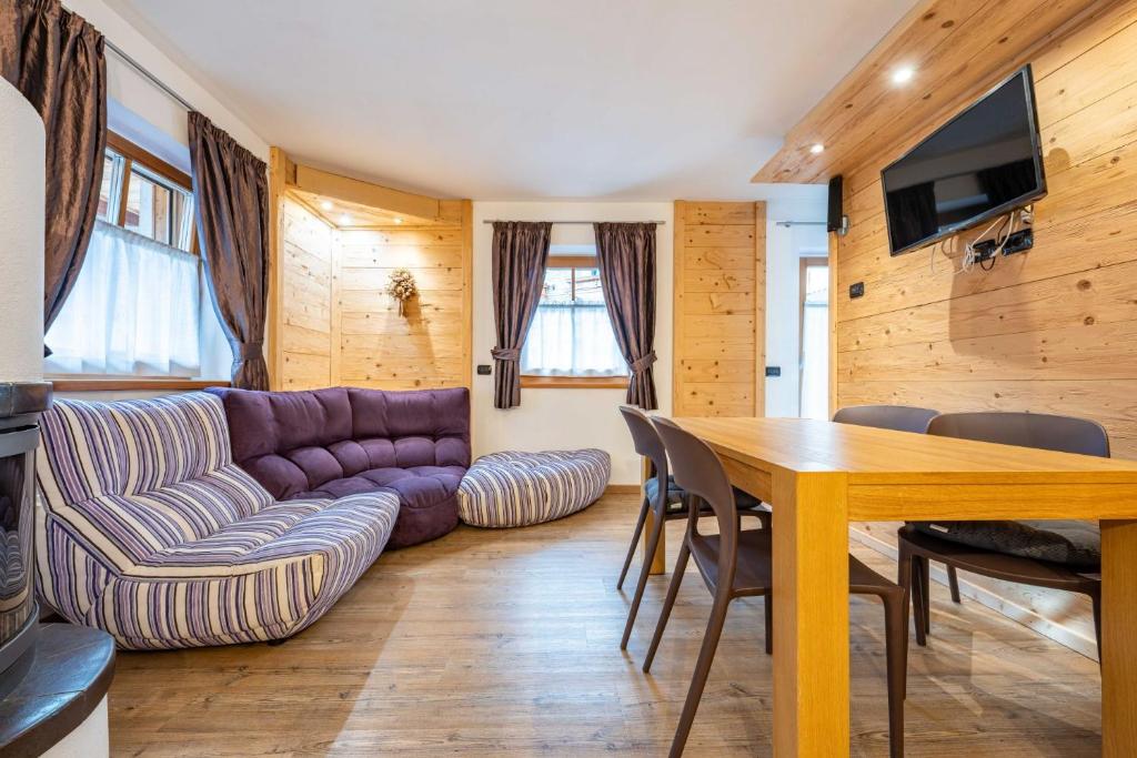 a living room with a couch and a table at Cesa Rosy in Campitello di Fassa