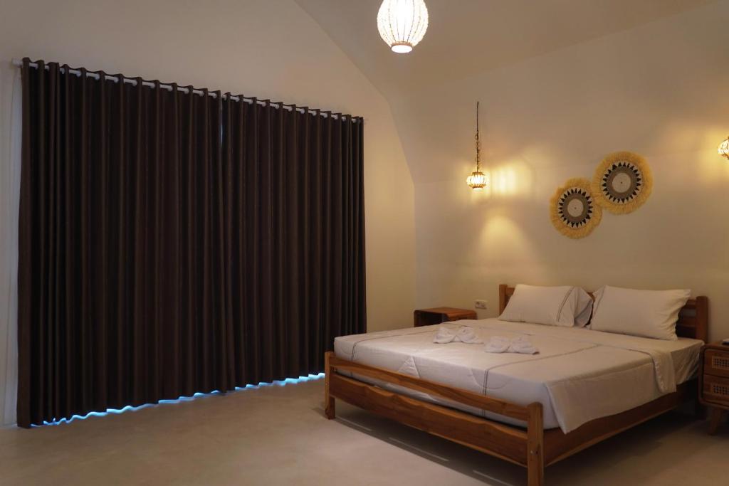 Postel nebo postele na pokoji v ubytování Jungle Bungalows