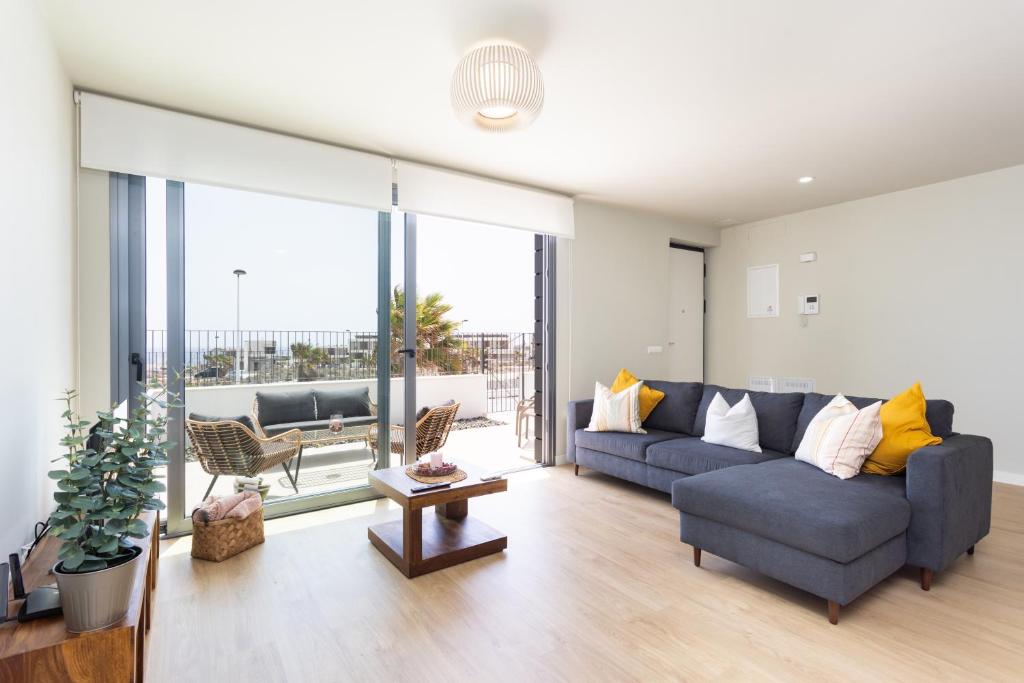 AbadesにあるHome2Book Orballo Sea Views Apt, Terrace&Poolのソファとテーブルのあるリビングルーム