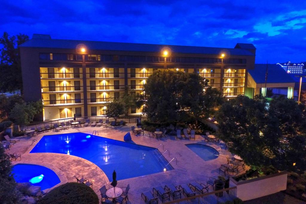 a hotel with a large swimming pool at night at Quality Inn Near the Island Pigeon Forge in Pigeon Forge