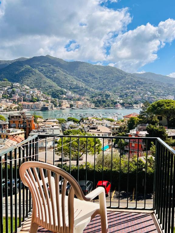 a chair on a balcony with a view of a city at Eurotel 406 in Rapallo