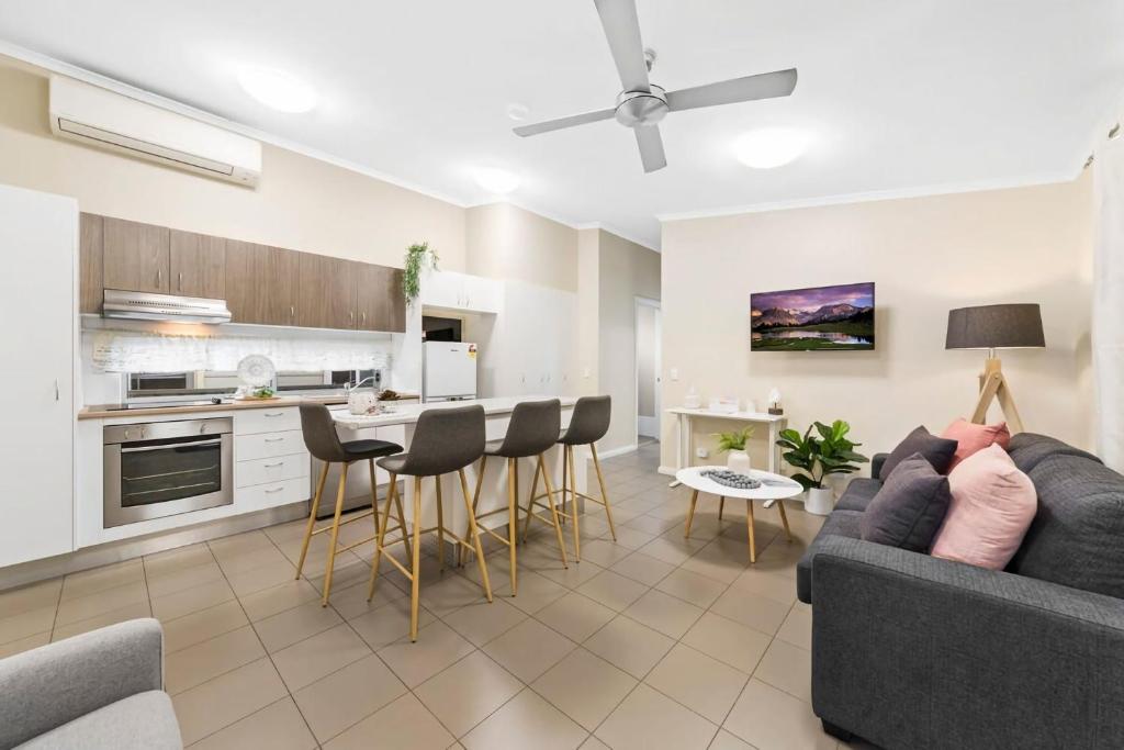 a living room with a couch and a kitchen at Umina Myrtle Bungalow Sleeping 4 Guests in Blackwall