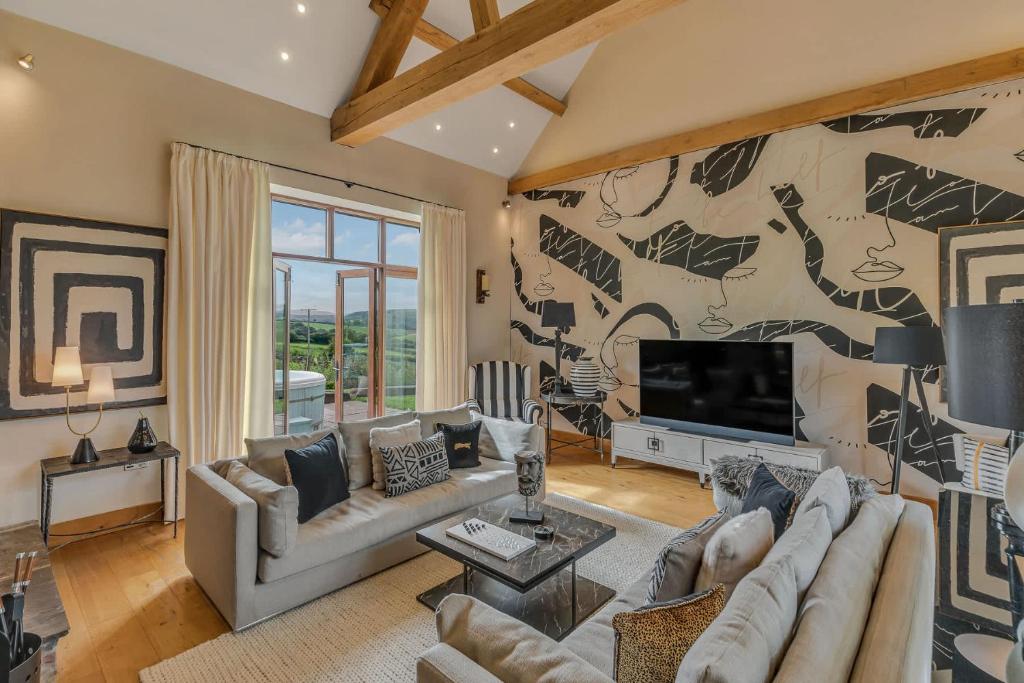 a living room with a couch and a tv at Hilltop View with Hot Tub in Brecon