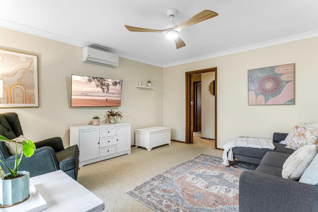 a living room with a couch and a table at Hidden Gem In Woonona in Woonona