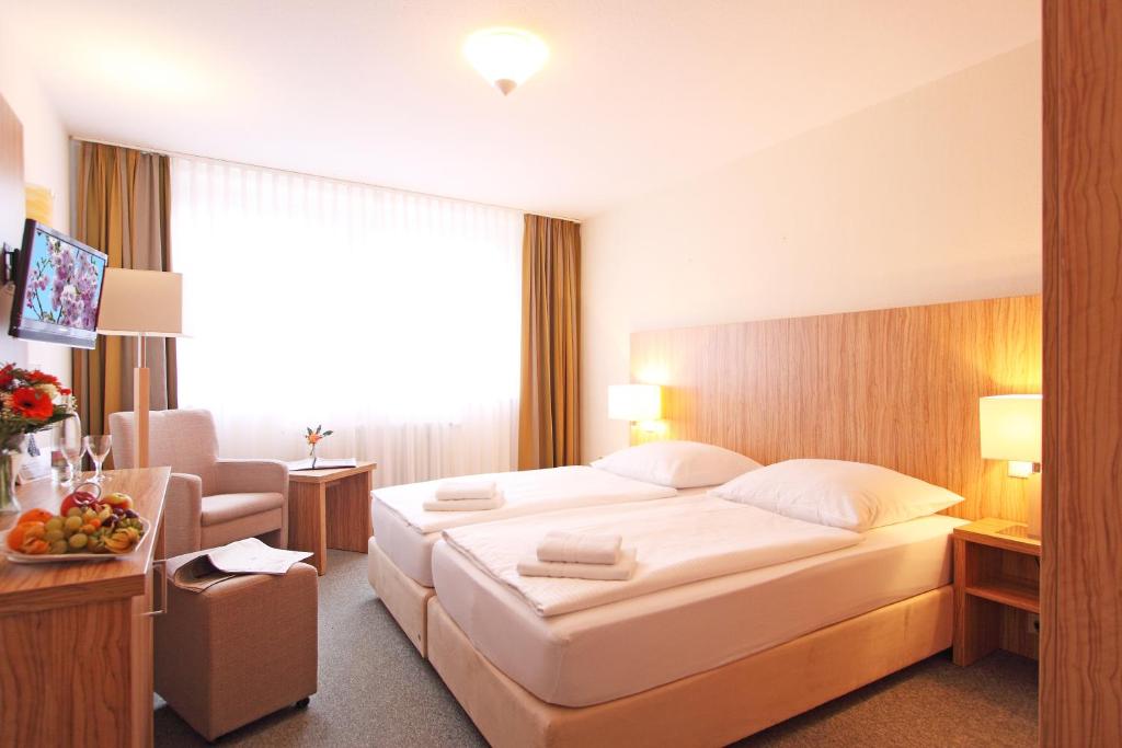 Postel nebo postele na pokoji v ubytování Akzent Hotel Am Burgholz