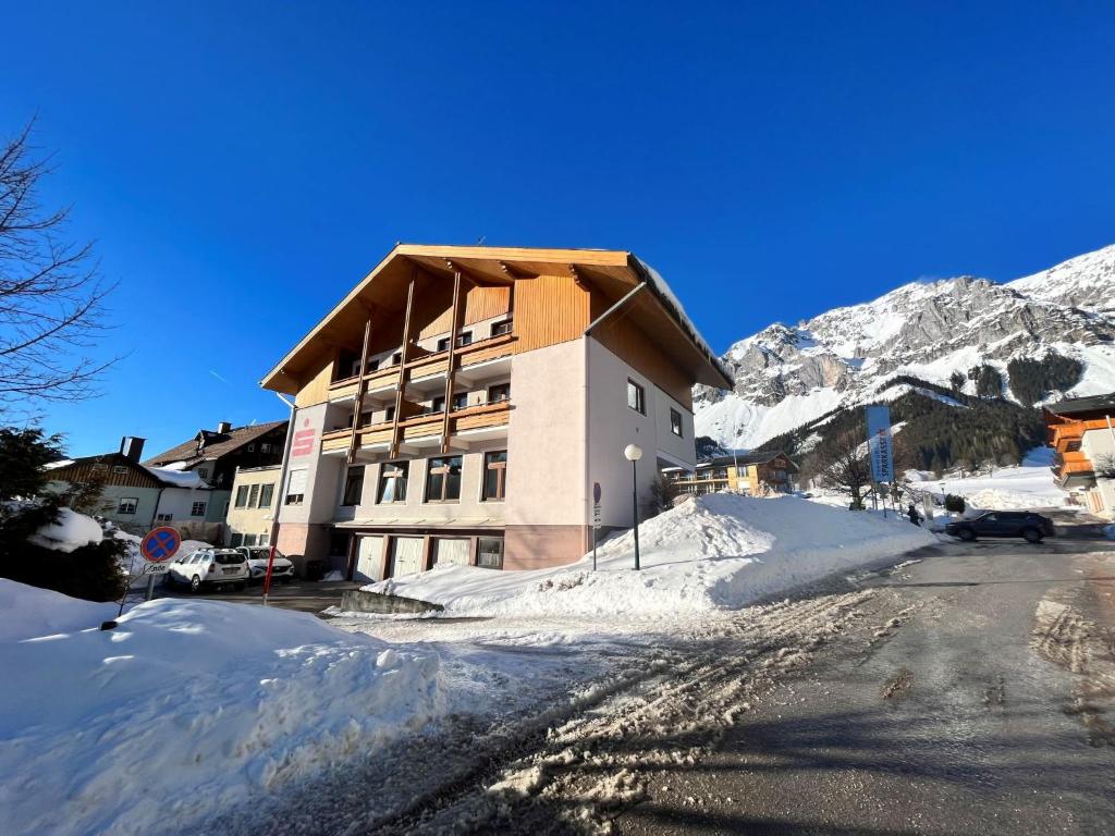 a building in the mountains with snow on the ground at Apartment Annis Nest by Interhome in Ramsau am Dachstein