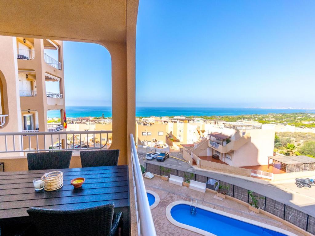 a balcony with a table and a view of the ocean at Apartment El Pinar de San Ginés by Interhome in La Azohía