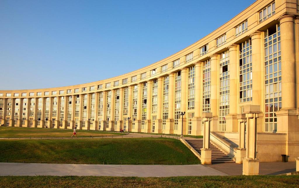 a large yellow building with stairs in front of it at Montpellier: appart cozy et spacieux au centre in Montpellier