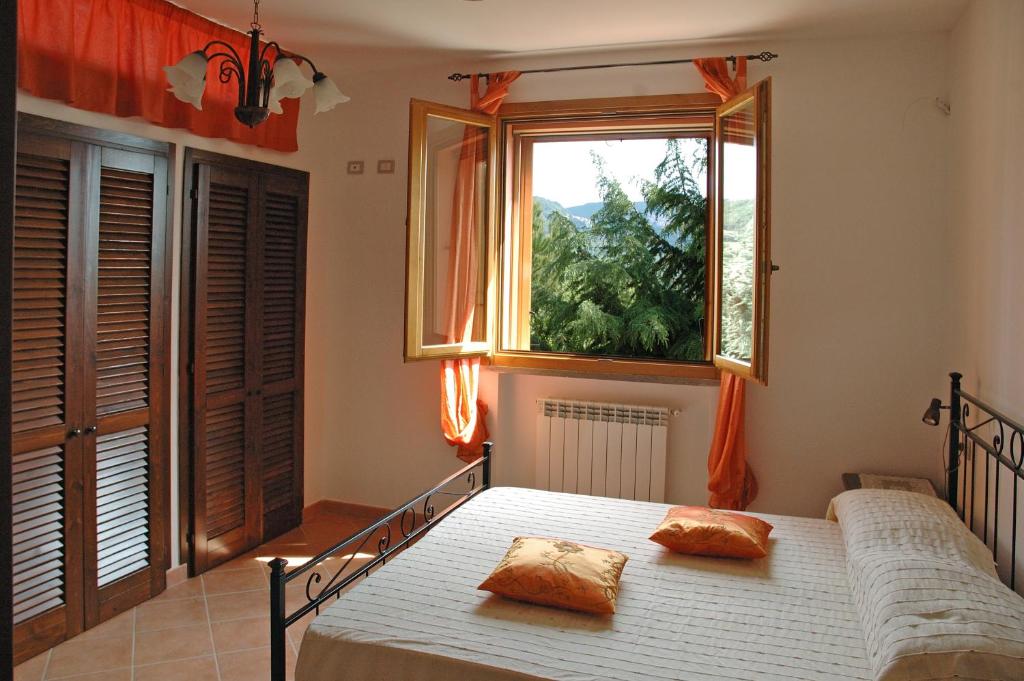 Postel nebo postele na pokoji v ubytování Agriturismo Podere Gozzuto