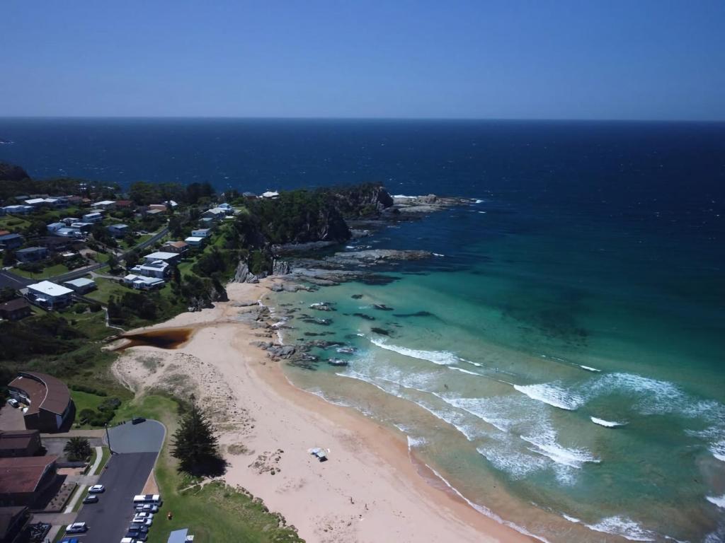 an aerial view of a beach and the ocean at Ocean Views Walk to Malua Beach EV & Pet Friendly in Malua Bay
