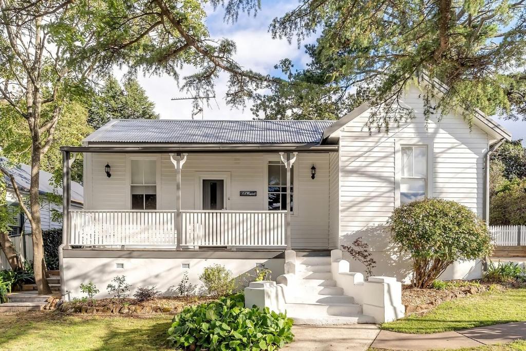 a white house with a porch and stairs at Loch Lomond Home Mountain Retreat Katoomba in Katoomba