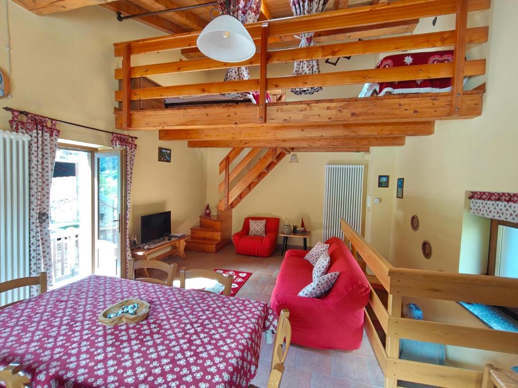 a living room with a bed and a staircase at Casa Vacanze: Maison Des Gnomes in Challand Saint Anselme