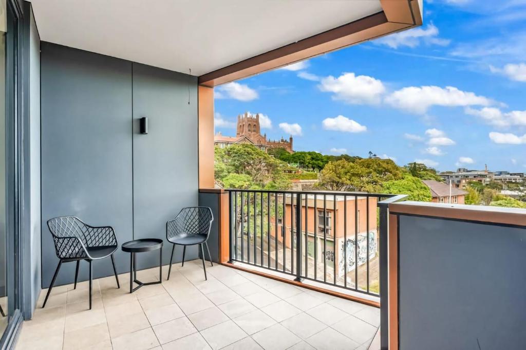 Un balcón con dos sillas y vista a un castillo. en Luxury Herald Building Newcastle, en Newcastle