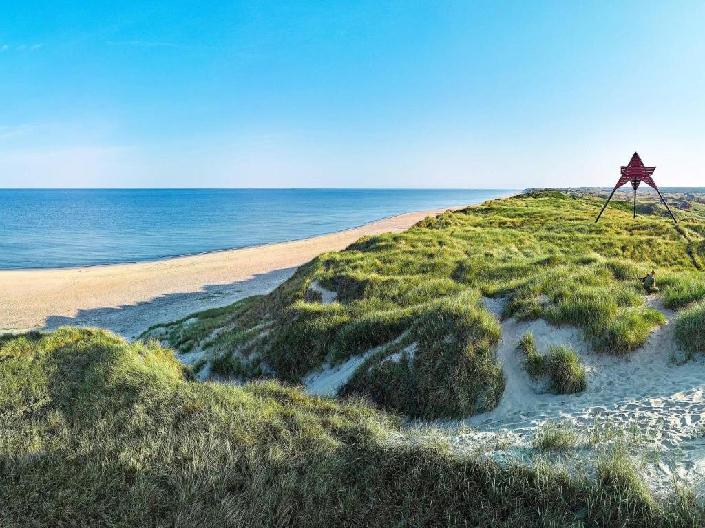a star on a sandy beach next to the ocean at Apartment in Holiday Park in Vederso Klit in Ulfborg