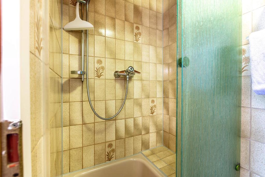 a bathroom with a shower with a tub at Haus Am Bühl in Schönau im Schwarzwald