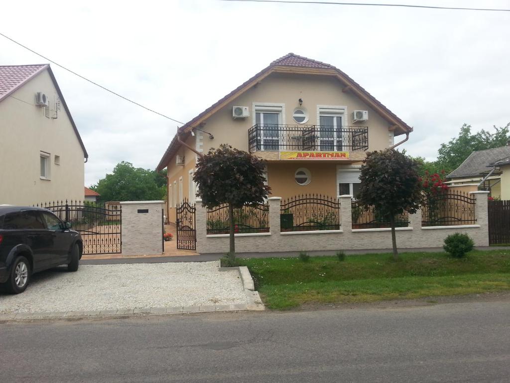 ein Haus mit einem davor geparkt in der Unterkunft Marinica Apartman in Hajdúszoboszló