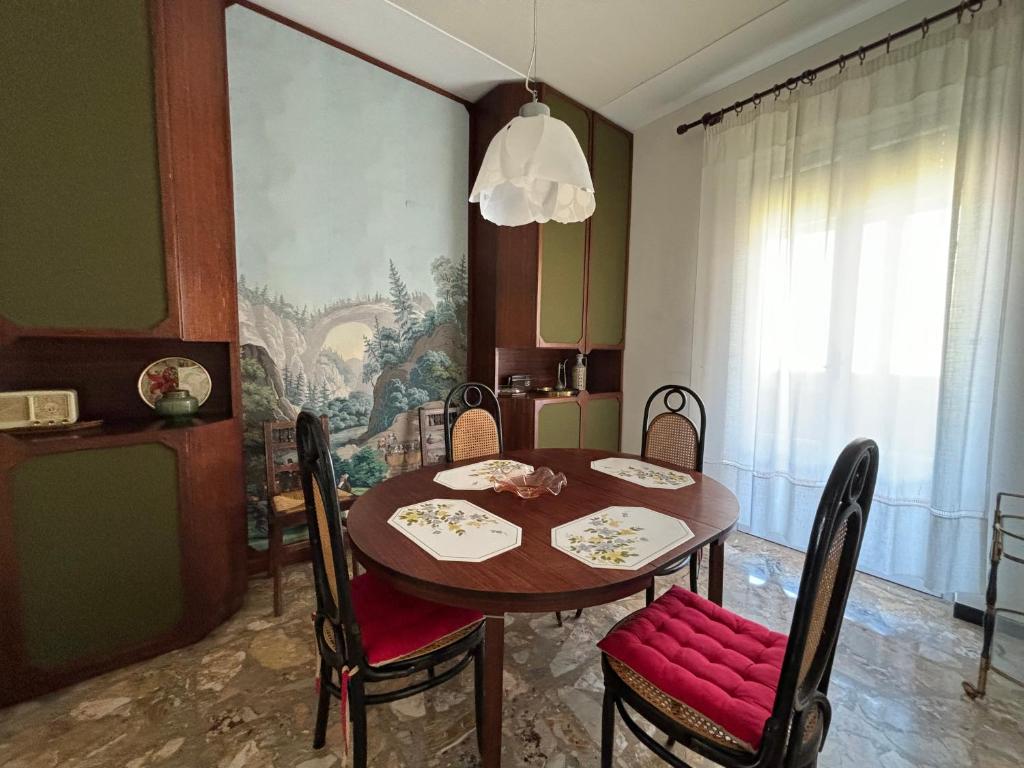 a dining room with a wooden table and chairs at Casa Cele centro città vista mare in Ventimiglia
