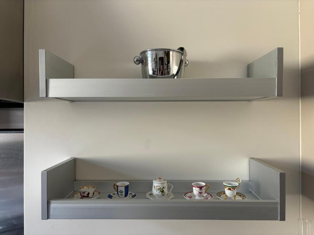 a white shelf with a pot on top of it at Casa Cele centro città vista mare in Ventimiglia