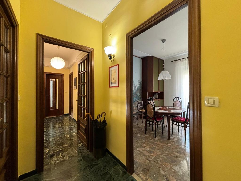 a hallway with a dining room and a dining table at Casa Cele centro città vista mare in Ventimiglia