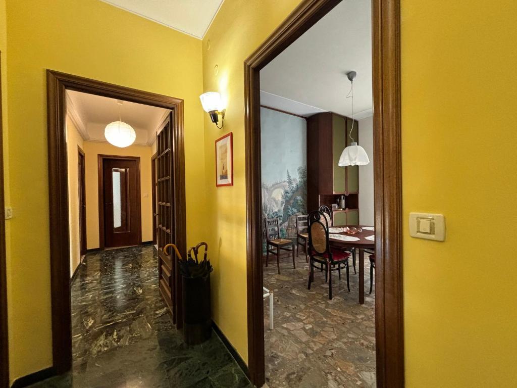 a hallway with a dining room and a dining table at Casa Cele centro città vista mare in Ventimiglia