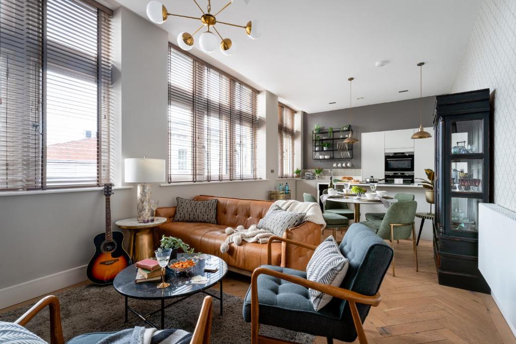 a living room with a couch and a table at Cathedral Yard - Art Deco Luxury (Exeter) in Exeter