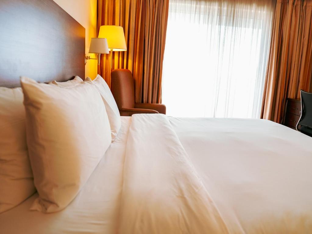 Postel nebo postele na pokoji v ubytování Abuja Continental Hotel