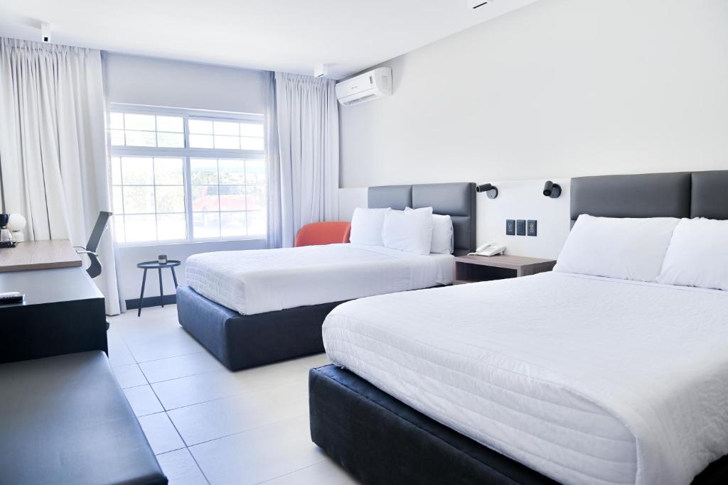 Postel nebo postele na pokoji v ubytování Hotel Sicomoro