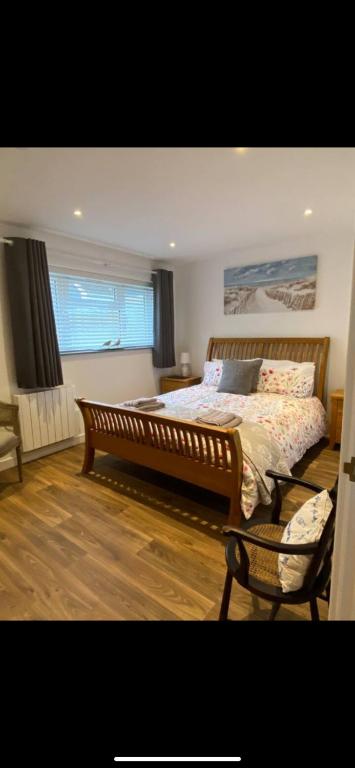 a bedroom with a large bed and a window at Seashells in Padstow