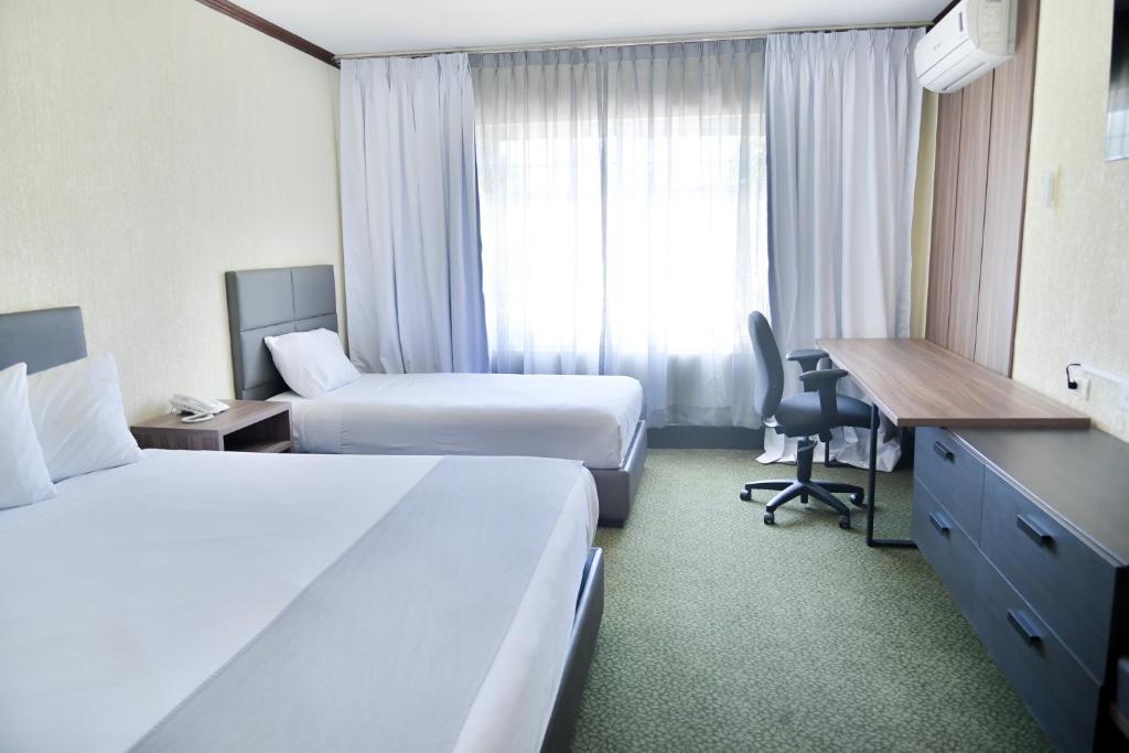 Postel nebo postele na pokoji v ubytování Hotel Sicomoro
