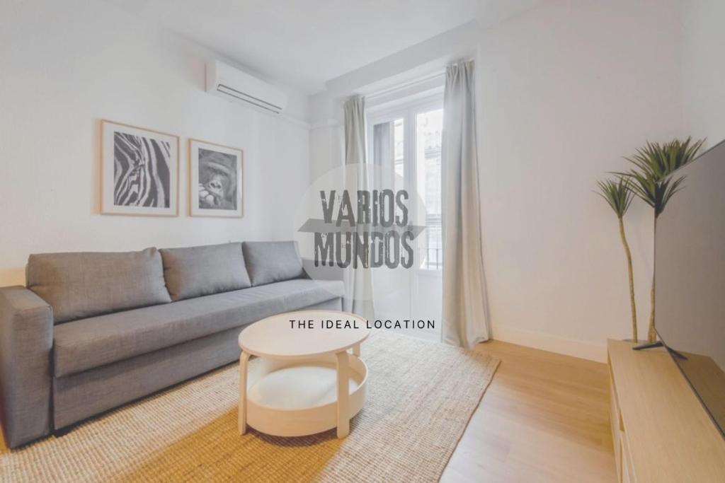 a living room with a couch and a table at Comodo y centrico Loft en calle Carretas - Madrid Centro in Madrid