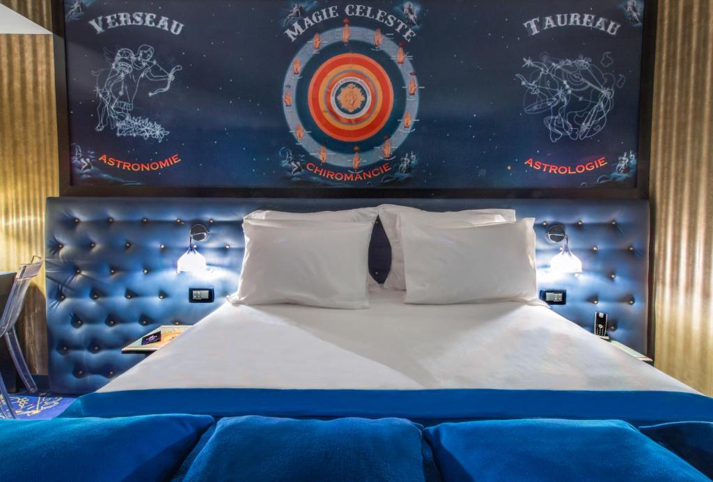 a bed in a room with a target on the wall at Hotel Splendor Elysées in Paris