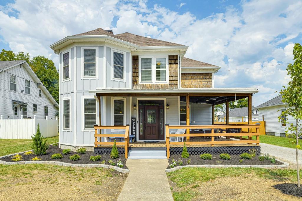 a white house with a porch with two benches at Lebanon Retreat Decks, Fire Pit and Yard in Lebanon