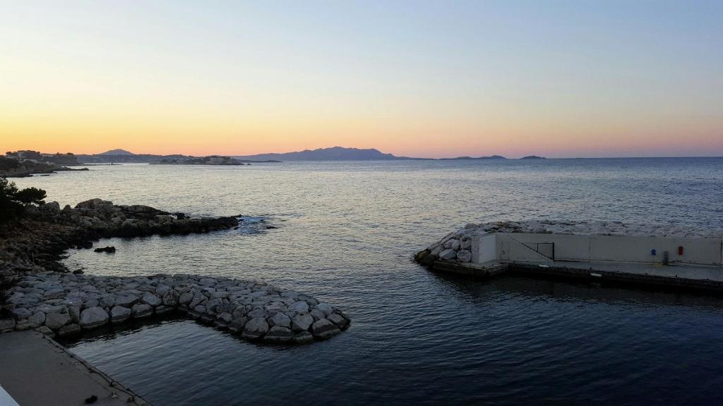 a large body of water with a boat in it at Appart vue d'exception sur la mer in Bandol