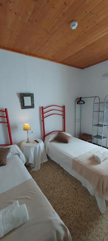Ένα ή περισσότερα κρεβάτια σε δωμάτιο στο Rocio Rooms