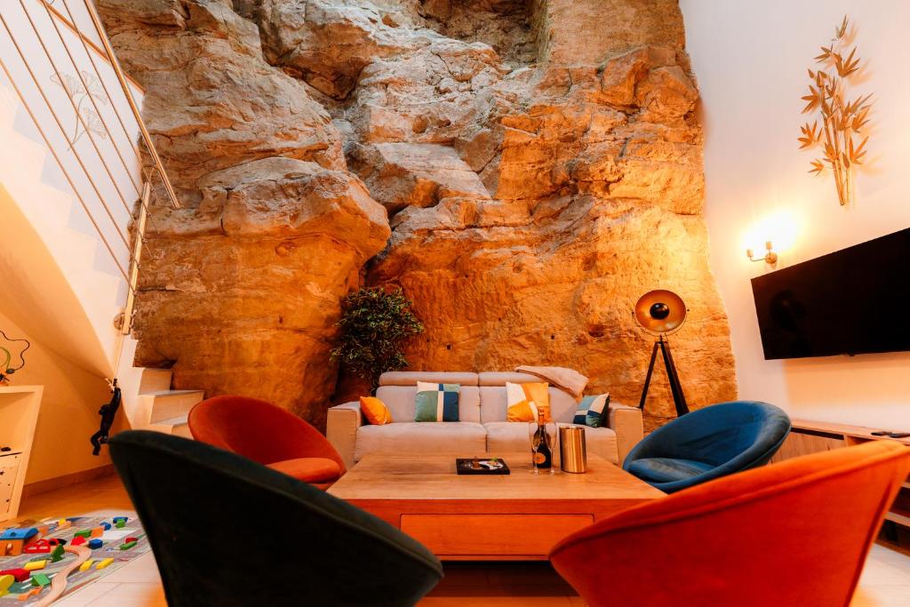 a living room with a rock wall at Le Secret du Château in Beyren-lès-Sierck