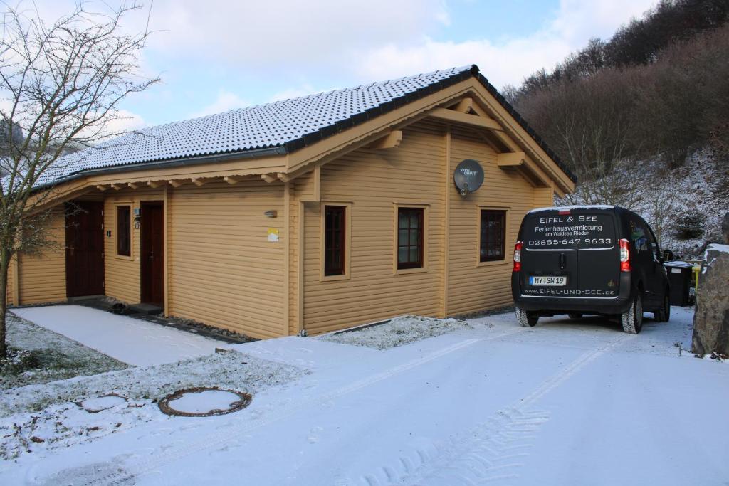 a van parked in front of a house in the snow at Ferienhaus Maja in Rieden