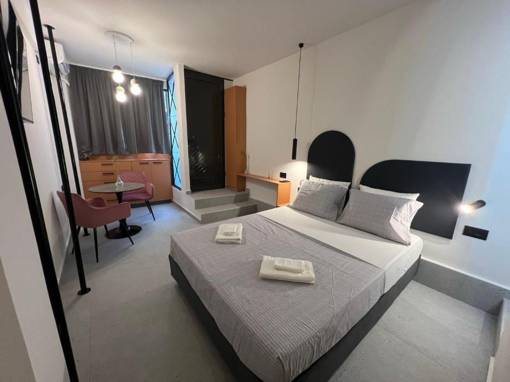 a bedroom with a bed with two towels on it at Apartment Falirou in Athens
