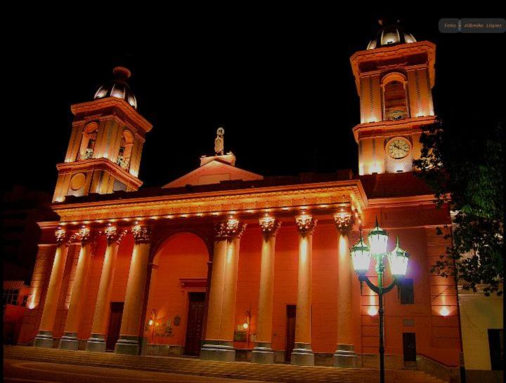 a building with two towers and a clock tower at Departamento a 150 metros de la catedral con cochera in San Fernando del Valle de Catamarca