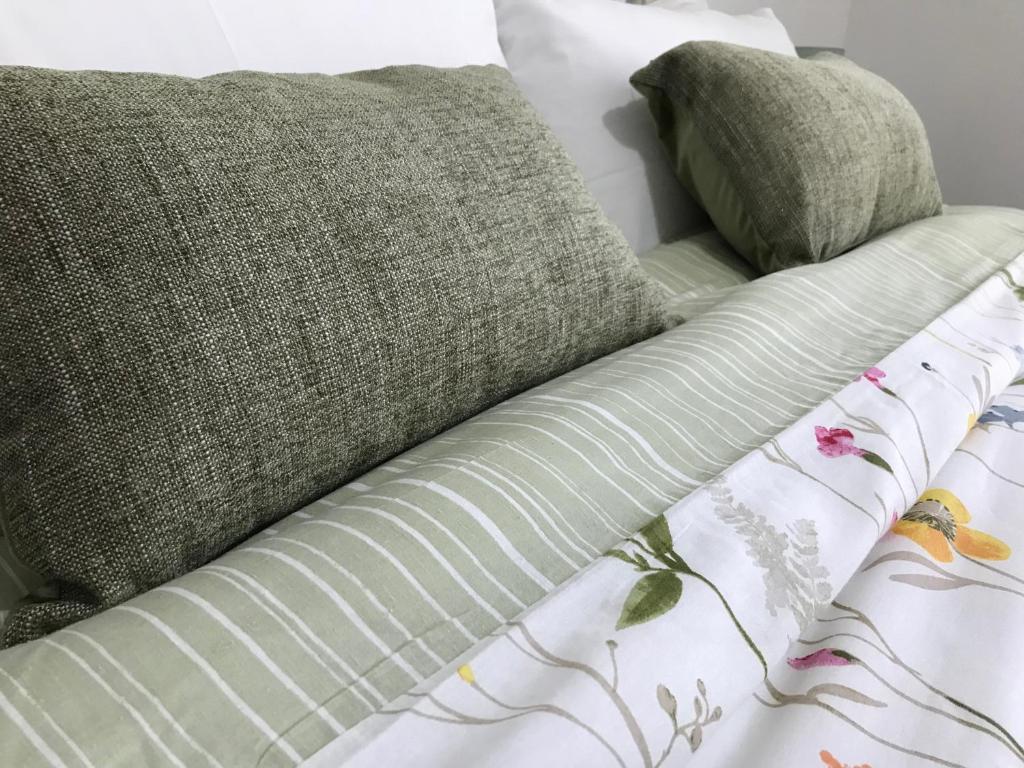 a bed with two pillows on top of it at Cliff Cottage in Valtos