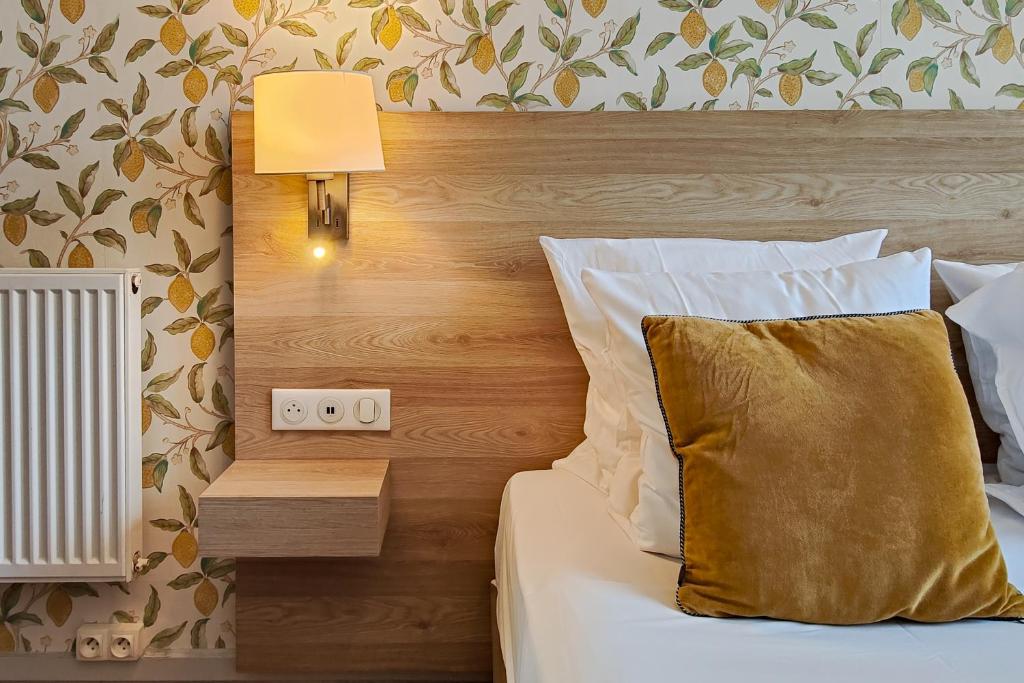 Un ou plusieurs lits dans un hébergement de l'établissement Aparthotel AMMI Nice Massena - ex Ajoupa