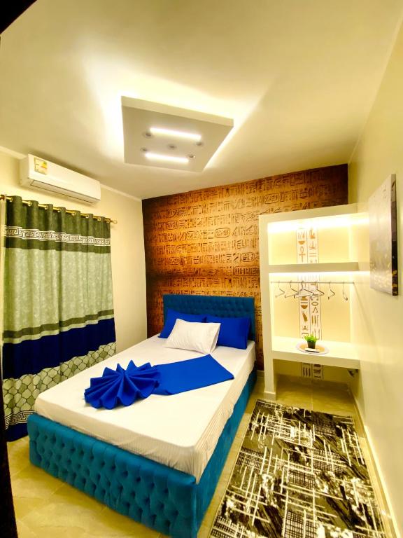 a bedroom with a bed with a blue bow on it at Horus pyramids view in Cairo